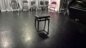 Piano Stool. Positioned centre stage. 